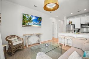 a living room with a couch and a table at Beach Access Condo-Walk to Downtown-Pets Welcome w/ Fee in Pass Christian