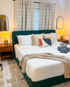 a bedroom with a large green bed with pillows at Waterfront home with Firepit and Foosball Table in Fruitland Park