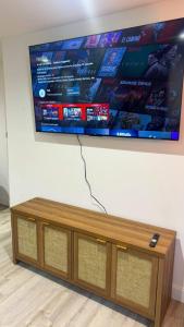 a large flat screen tv hanging on a wall at Waterfront home with Firepit and Foosball Table in Fruitland Park