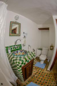 a bathroom with a sink and a toilet at Riad Dar Bahja - More Than a Stay in Fès
