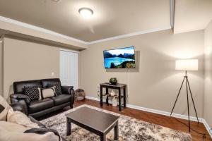 a living room with a couch and a table at Spacious 3 bed 3 bath Apartment No stairs in Buffalo