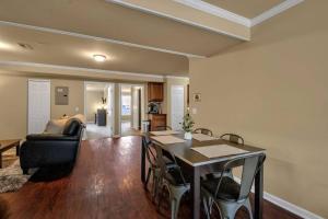 a living room with a table and a couch at Spacious 3 bed 3 bath Apartment No stairs in Buffalo +18 photos