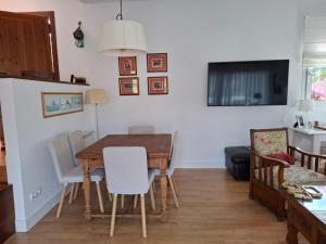 a dining room with a table and chairs at La Pabla in Colunga +7 photos