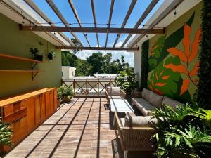 an outdoor patio with couches and tables and plants at Villa Palmera in Las Terrenas