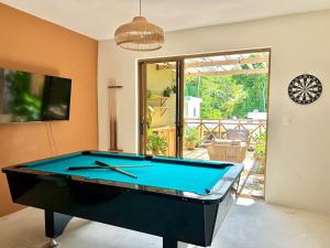 a pool table in a living room with ahibition at Villa Palmera in Las Terrenas
