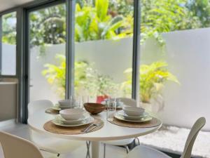 a white table with plates and bowls on it at Villa Hazel in Las Terrenas