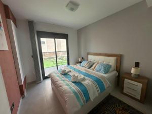 a bedroom with a bed and a large window at Flamingo del Guardamar in Guardamar del Segura +21 photos
