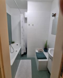 a white bathroom with a tub and a sink at Francesca Apartmanlakása in Tapolca +17 photos