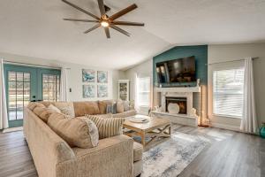 a living room with a couch and a fireplace at Modern Coastal Escape 1 Mi to Anclote River Park in Anclote