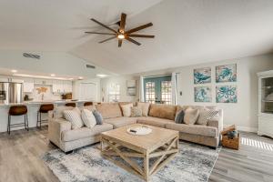 a living room with a couch and a ceiling fan at Modern Coastal Escape 1 Mi to Anclote River Park in Anclote