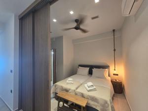 a bedroom with a bed and a ceiling fan at Ilia Suites ''Paralia'' in Ilia