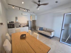 a living room with a wooden table and a couch at Ilia Suites ''Paralia'' in Ilia