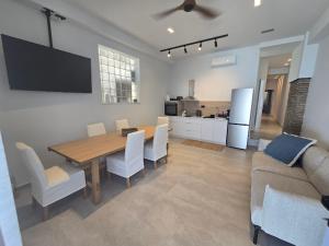 a kitchen and dining room with a table and a couch at Ilia Suites ''Paralia'' in Ilia +7 photos