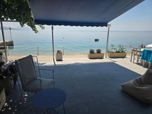 a patio with a view of the beach and the ocean at Ilia Suites ''Paralia'' in Ilia