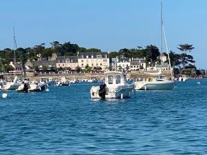 a group of boats docked in a body of water at Loki Rivoli Cottage in Locquirec