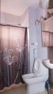 a bathroom with a toilet and a shower at Apartment 25B11 Mixta in Dakar +29 photos