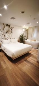 Ένα ή περισσότερα κρεβάτια σε δωμάτιο στο Up Hotel Boutique