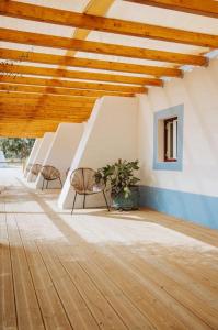 a room with two chairs and a wooden ceiling at Herdade da Maceira in São Luis +62 photos