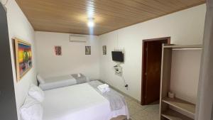 Ένα ή περισσότερα κρεβάτια σε δωμάτιο στο Pousada Café Na Mata