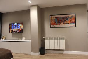 a room with a wall with a picture and a radiator at Old Baku Boutique Hotel in Baku