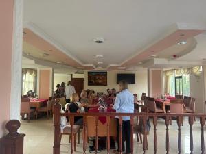 a group of people sitting at a table in a restaurant at Sabean International Hotel in Āksum