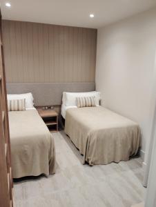 Ένα ή περισσότερα κρεβάτια σε δωμάτιο στο Hotel Vélez