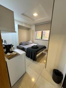 a small bedroom with a bed and a window at Studio Residencial Casa Mauá III in Rio de Janeiro +54 photos