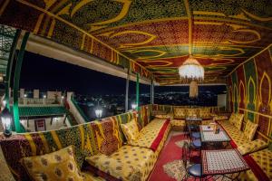 a room with couches and a chandelier at Riad Dar Bahja - More Than a Stay in Fès