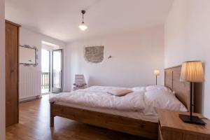 a bedroom with a bed and a table and a lamp at Vila Friuli Karst in Komen +32 photos