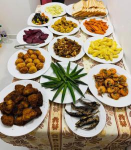 a table full of plates of food on a table at Lishan Nature Resort - Kataragama in Gotamegama