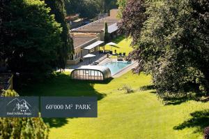 an aerial view of a house with a swimming pool at Hotel Schloss Ragaz in Bad Ragaz