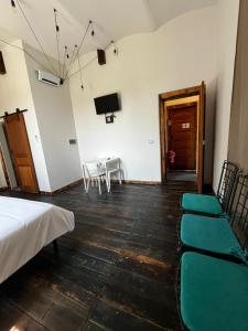 a room with a bed and a table and chairs at La Locanda della Mandria 2 in Venaria Reale