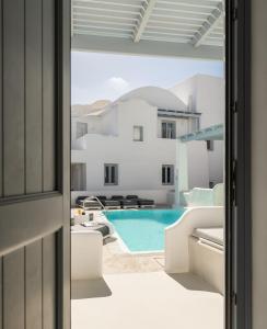 a view of a swimming pool from a house at Palmariva Villas in Fira