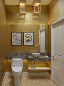 a bathroom with a toilet and a sink at Cápsula Hotel in Florianópolis