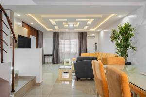 a living room with a couch and a table at Affordable Lekki Luxury Homes in Lagos +4 photos