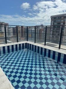 a swimming pool on the roof of a building at Edifício Atlantis Hotel in Maceió