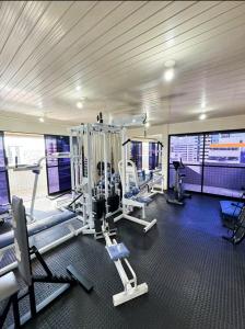 a gym with treadmills and machines in a building at Edifício Atlantis Hotel in Maceió