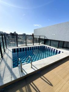 a swimming pool on the roof of a building at Edifício Atlantis Hotel in Maceió