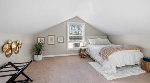 a bedroom with a bed and a window at Luxurious 1875 centrally located Canton Akron home, large primary BR & sunset view in Uniontown