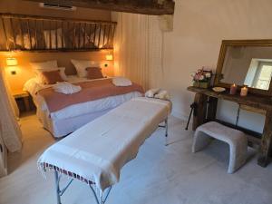 a bedroom with two beds and a mirror at Au fil de l'O in Semur-en-Auxois