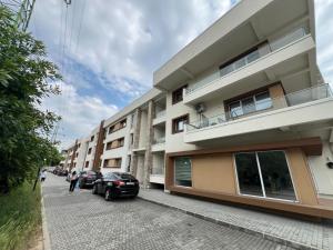 a building with two cars parked in front of it at Lapus Residence Apartament in Craiova
