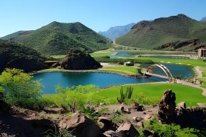a view of a golf course with mountains in the background at Depas WAICURA'S in Loreto