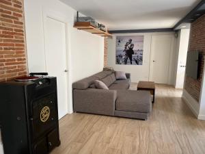 a living room with a couch and a tv at Plus in Logroño
