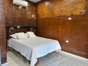 a small bedroom with a bed in a room at Guest-House ocean view in Las Galeras 2 in Las Galeras