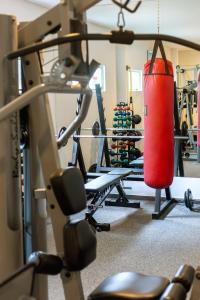 a gym with a red punching bag hanging from a rack at Baía Branca Beach Resort in Tamandaré