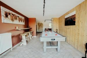 a room with a ping pong table in it at Les Landes de Bruyères in Waimes