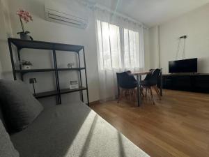 a living room with a table and a television at Cozy Apartment Madrid in Madrid