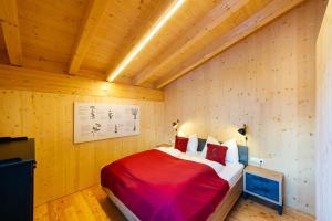 a bedroom with a bed in a wooden room at Ferienhaus Blauer Vogel - kostenfreie Saunanutzung in Prägraten