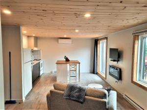 a living room with a couch and a kitchen at La Passion #204 - Loft with private balcony and view in Sainte-Lucie-de-Doncaster +21 photos