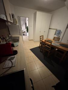 a kitchen and dining room with a table and chairs at Bucharest Residence in Bucharest +7 photos